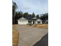 Charming single-story home boasting a curved driveway and attached two-car garage at 105 Watermelon Dr, Franklinton, NC 27525