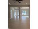 Open-concept living room with hardwood floors and views into the entry and dining room at 105 Watermelon Dr, Franklinton, NC 27525