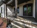 Inviting front porch with stone steps and decorative iron railing, leading to the front door at 144 W Beech Slope Ct, Chapel Hill, NC 27517