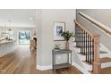 Bright entryway featuring hardwood floors, staircase with decorative railing, and open access to living area at 417 E Moore St, Apex, NC 27502