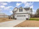 Two-story house with white siding, gray roof, and stone accents at 49 Lupin Dr, Smithfield, NC 27577