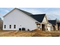 Newly constructed home showcasing a side view, featuring vinyl siding and a brick base at 1055 Fairhaven Dr # 56, Mebane, NC 27302