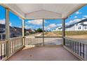 Relaxing screened porch with a view of the neighborhood and a partially wooded area at 1055 Fairhaven Dr # 56, Mebane, NC 27302