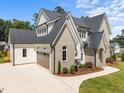 Charming two-story home boasts a brick and siding exterior, a spacious driveway, and professionally landscaped grounds at 701 Dartmouth Rd, Raleigh, NC 27609