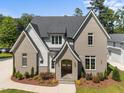 Beautiful two-story home with painted brick, white siding, lush landscaping, and inviting entrance at 701 Dartmouth Rd, Raleigh, NC 27609