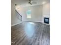 Spacious living room featuring hardwood floors, a fireplace, and a staircase at 321 Hopewell Branch Ct, Smithfield, NC 27577