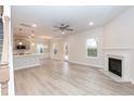 Open-concept living space featuring a fireplace, kitchen, and natural light-filled windows at 347 Hopewell Branch Ct, Smithfield, NC 27577