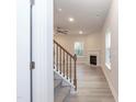 Inviting living room showcasing the hardwood floors, fireplace and the staircase with wooden railing at 347 Hopewell Branch Ct, Smithfield, NC 27577
