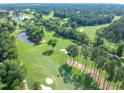 Aerial view of a golf course community with lush greenery and serene ponds at 102 Preston Pines Dr, Cary, NC 27513