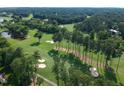 Aerial perspective of a golf course featuring fairways, sand traps, and ponds at 102 Preston Pines Dr, Cary, NC 27513