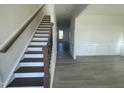 Bright entryway with an elegant staircase and view of the living area at 1528 Maelyn Way, Fuquay Varina, NC 27526