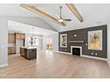Spacious living room with vaulted ceiling, fireplace, and an open floor plan into the modern kitchen at 240 Sequoia Dr, Louisburg, NC 27549