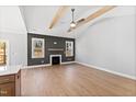 Bright living room features vaulted ceilings, wood beam accents, and a cozy fireplace with a mantle at 240 Sequoia Dr, Louisburg, NC 27549