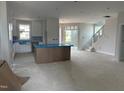 Open-concept interior with natural light, showcasing the kitchen area with island, stairs and a modern design at 2412 Adrift Road, Fuquay Varina, NC 27526