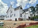 A view of the side and rear of the house showcasing its architectural design with the roof installed at 3301 Dell Dr, Raleigh, NC 27609