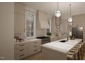 Modern kitchen features white cabinets, marble countertops, and a large island at 3301 Dell Dr, Raleigh, NC 27609
