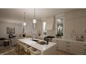 Open concept kitchen with island, stainless steel appliances, and view into living room at 3301 Dell Dr, Raleigh, NC 27609