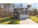 Beautiful two-story home featuring a manicured lawn, two-car garage, and inviting front porch at 145 Leisure Ln, Louisburg, NC 27549