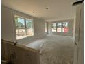 Bright living room featuring multiple large windows for ample natural light at 2400 Adrift Rd, Fuquay Varina, NC 27526