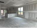 Spacious living area with drywall, large windows, and lots of light at 2400 Adrift Rd, Fuquay Varina, NC 27526