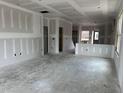 Open-concept living space featuring drywall and large window with natural light at 2400 Adrift Rd, Fuquay Varina, NC 27526