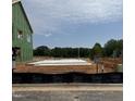 New home under construction features a concrete foundation on a spacious lot in a developing community at 2404 Adrift Rd, Fuquay Varina, NC 27526