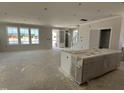 Open-concept living area filled with natural light, showcasing ample space and modern design at 2404 Adrift Rd, Fuquay Varina, NC 27526