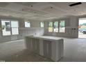 Bright living room showcasing drywall, recessed lighting, and many windows at 2404 Adrift Rd, Fuquay Varina, NC 27526