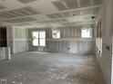Open-concept living room featuring drywall, recessed lighting, and many windows for natural light at 2404 Adrift Rd, Fuquay Varina, NC 27526