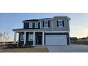 Charming two-story home boasts a two-car garage and inviting front porch at 111 Brodhead Dr, Fuquay Varina, NC 27526