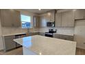 Modern kitchen featuring stainless appliances, quartz counters, and ample storage at 111 Brodhead Dr, Fuquay Varina, NC 27526