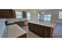 Spacious kitchen with a large island, wood cabinets, and stainless steel appliances at 159 Robert Howe Dr, Fuquay Varina, NC 27526