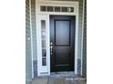 Close-up of the home's black front door with white trim at 210 Drayton Hall Ln, Sanford, NC 27330
