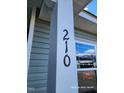 Close-up of a homes elegant black house number, '210' at 210 Drayton Hall Ln, Sanford, NC 27330