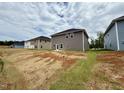 View of the backyard featuring new construction homes, showcasing lot size and neighborhood at 324 Bishop Ln, Sanford, NC 27330