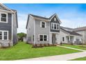 Charming two-story home with gray siding, white trim, and a well-manicured lawn at 757 Portland Rose Dr, Knightdale, NC 27545