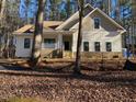 Two-story house with beige siding and a stone base at 6021 Inverness Cir, Sanford, NC 27332