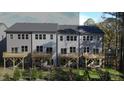 Townhomes with gray siding, white accents, decks, and fenced backyard at 2126 Opulent Oaks Ln # 14, Durham, NC 27713