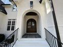 Elegant front entrance with arched double doors and brick facade at 4501 Bartlett Dr, Raleigh, NC 27609