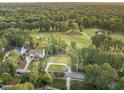 Aerial view of property surrounded by mature trees and golf course with an outlined building lot at 7000 North Ridge Dr, Raleigh, NC 27615