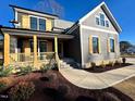 Gray farmhouse exterior with wooden shutters, porch, and landscaping at 90 Lambert Ln, Fuquay Varina, NC 27526