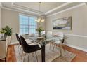 Elegant dining room featuring glass table, modern chairs, and stylish decor at 2551 Club Level Dr, Apex, NC 27523