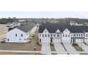 An aerial view of townhomes showcasing the community layout and surrounding landscape at 28 Nettle Ln # 235, Clayton, NC 27520