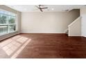 Spacious, bright living room featuring hardwood floors and a large window overlooking the yard at 330 Gilman Ln # 106, Raleigh, NC 27610