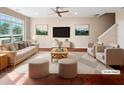 Bright, staged living room features hardwood floors, ceiling fan, and neutral décor at 330 Gilman Ln # 106, Raleigh, NC 27610