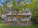 Rear exterior features a spacious deck with stone pillars overlooking a lush backyard at 32430 Archdale, Chapel Hill, NC 27517