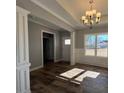 Formal dining room features hardwood floors, wainscoting, and a chandelier at 16 Dark Night Ln, Zebulon, NC 27597