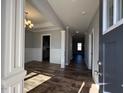 Bright and spacious entryway with hardwood floors and decorative columns at 16 Dark Night Ln, Zebulon, NC 27597