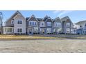 Row of attractive townhomes featuring modern designs, tidy landscaping, and inviting curb appeal at 3181 Mission Olive Pl # 346, New Hill, NC 27562