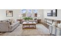Inviting living room with neutral tones, comfortable seating, a rustic coffee table, and abundant natural light at 222 Chestnut Oak Ln, Lillington, NC 27546